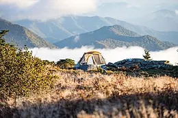 A tent pitched high in the mountains