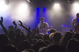 The front row pressed against the barrier