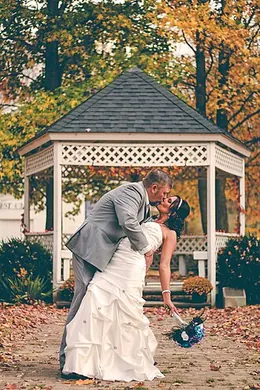 The groom dipping the bride for a kiss