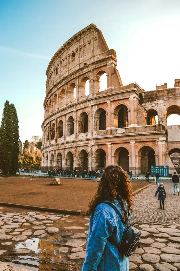 A woman pausing in front of the Colosseum