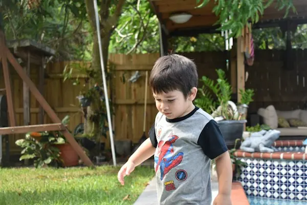 A boy playing in the backyard