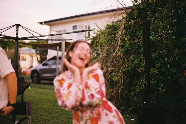 A woman laughing outdoors at the gathering