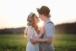 The couple laughing at sunset